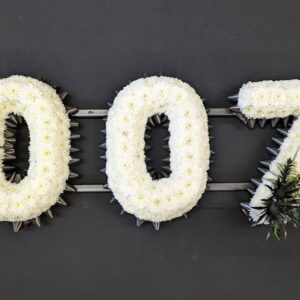 007 number funeral tribute in white chrysanthemums with dark ribbon and black foliage