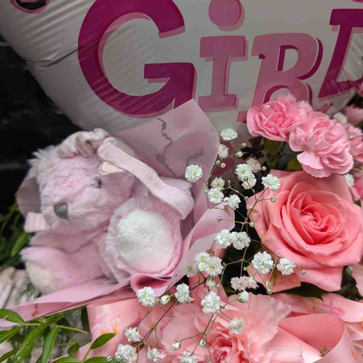 “Baby Girl” new baby gift with heart balloon, pink teddy bear and pink flower arrangement in a blush hat box on a wooden crate – Anastasia Florists Aberdeen - close up