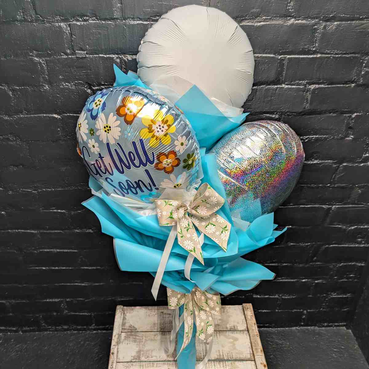balloon bouquet with blue wrapping - View