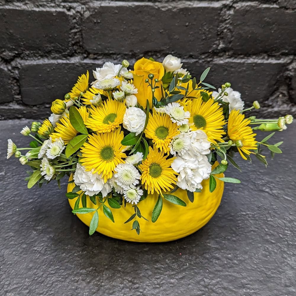 Vibrant yellow and white floral arrangement in a yellow Melon - Close up