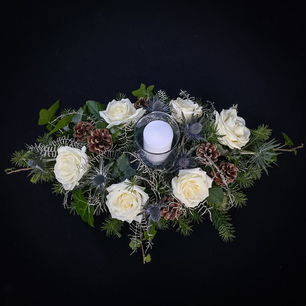 White rose and pine cone Christmas centrepiece