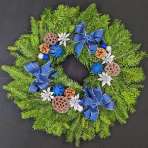 Blue and silver pine Christmas door wreath with bows, pinecones and lotus pods