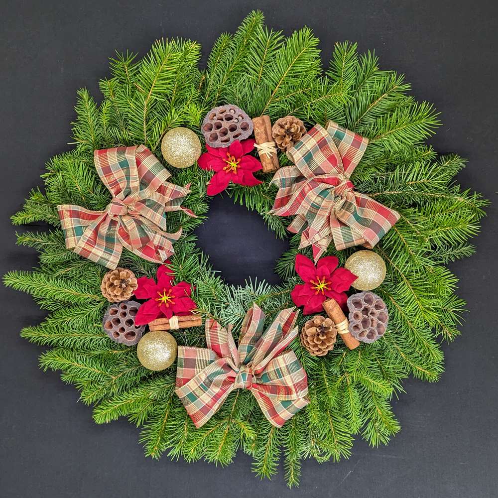 Pine Christmas door wreath with heritage tartan bows, gold baubles, poinsettia, pinecones and cinnamon