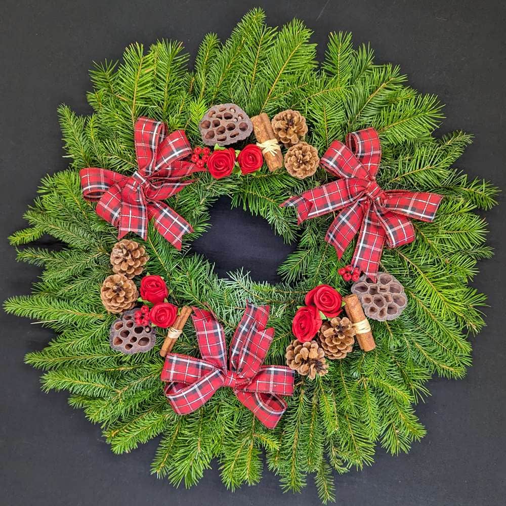 Red tartan pine Christmas door wreath with pinecones, lotus pods and cinnamon
