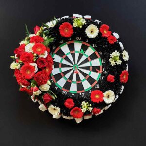 Darts themed funeral tribute with floral ring around a dartboard