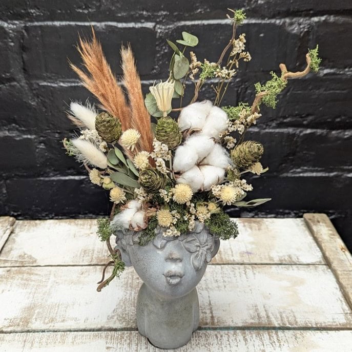 Dried flower face vase arrangement with cotton, cones, grasses and preserved foliage in a stone-style head vase – Anastasia Florists Aberdeen - Close Up