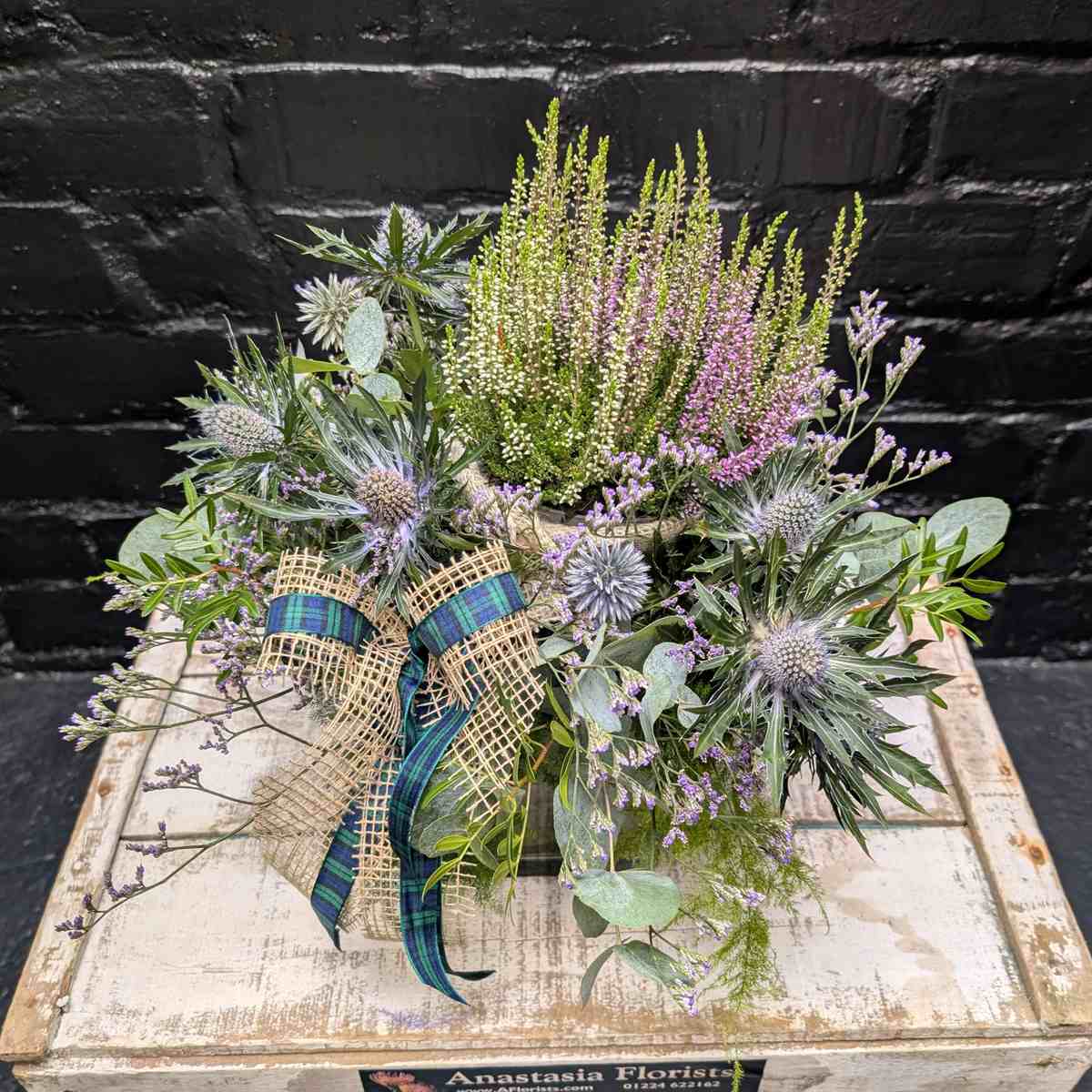 Scottish thistle and heather flower arrangement with lilac blooms, foliage and tartan ribbon in a glass cube vase – Anastasia Florists Aberdeen - Close Up