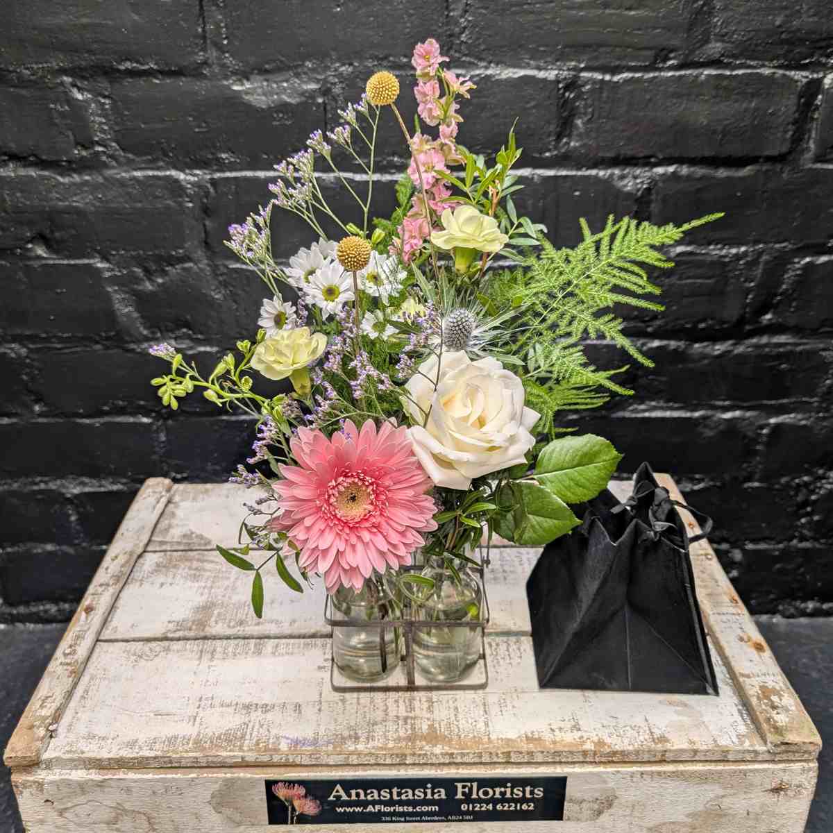 Charming bouquet in vintage-style milk bottles – side view