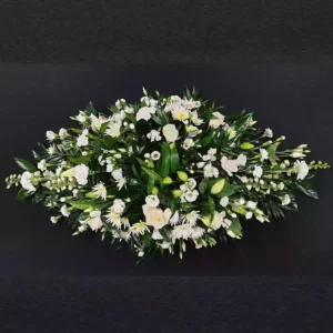 White lily, rose, and chrysanthemum funeral coffin spray