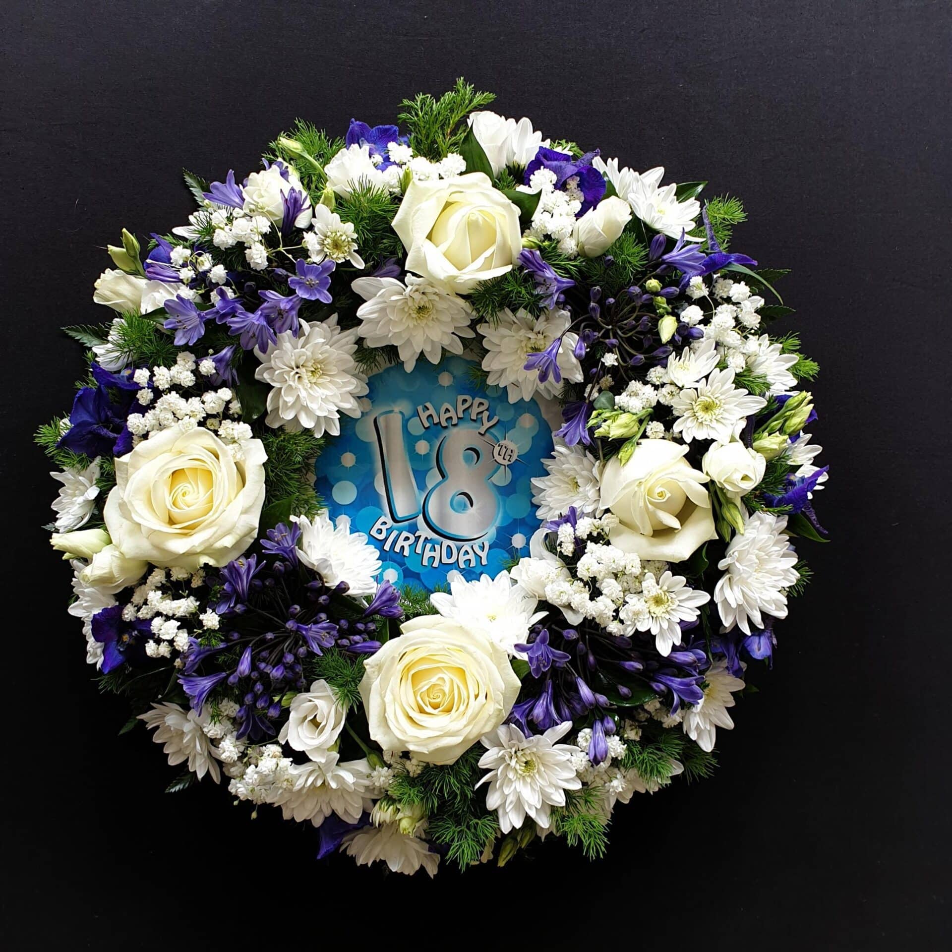 Funeral flower wreath with white roses and flowers