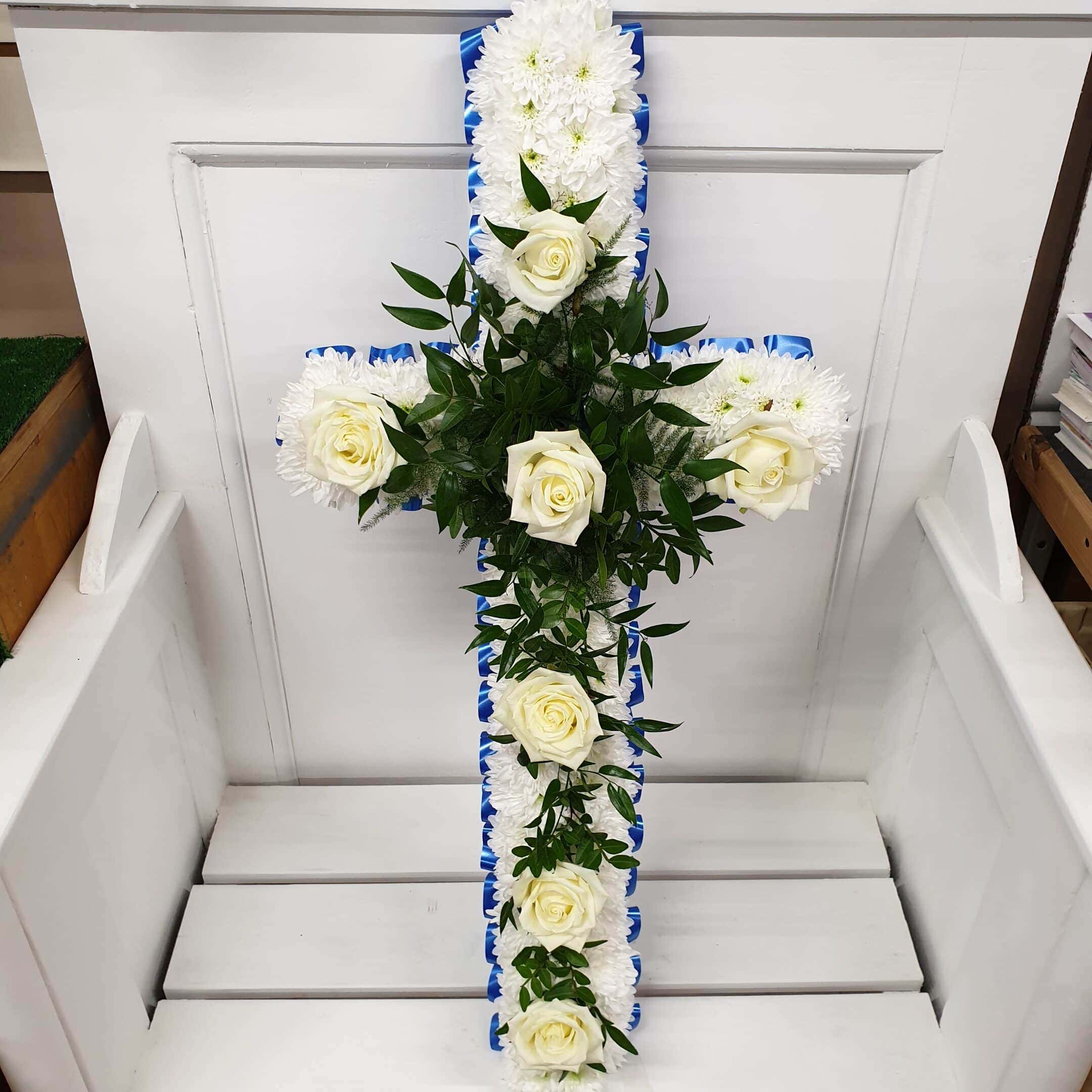 White rose and chrysanthemum funeral cross with blue ribbon edge