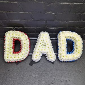DAD funeral letter tribute in white chrysanthemums with red and blue ribbon edging