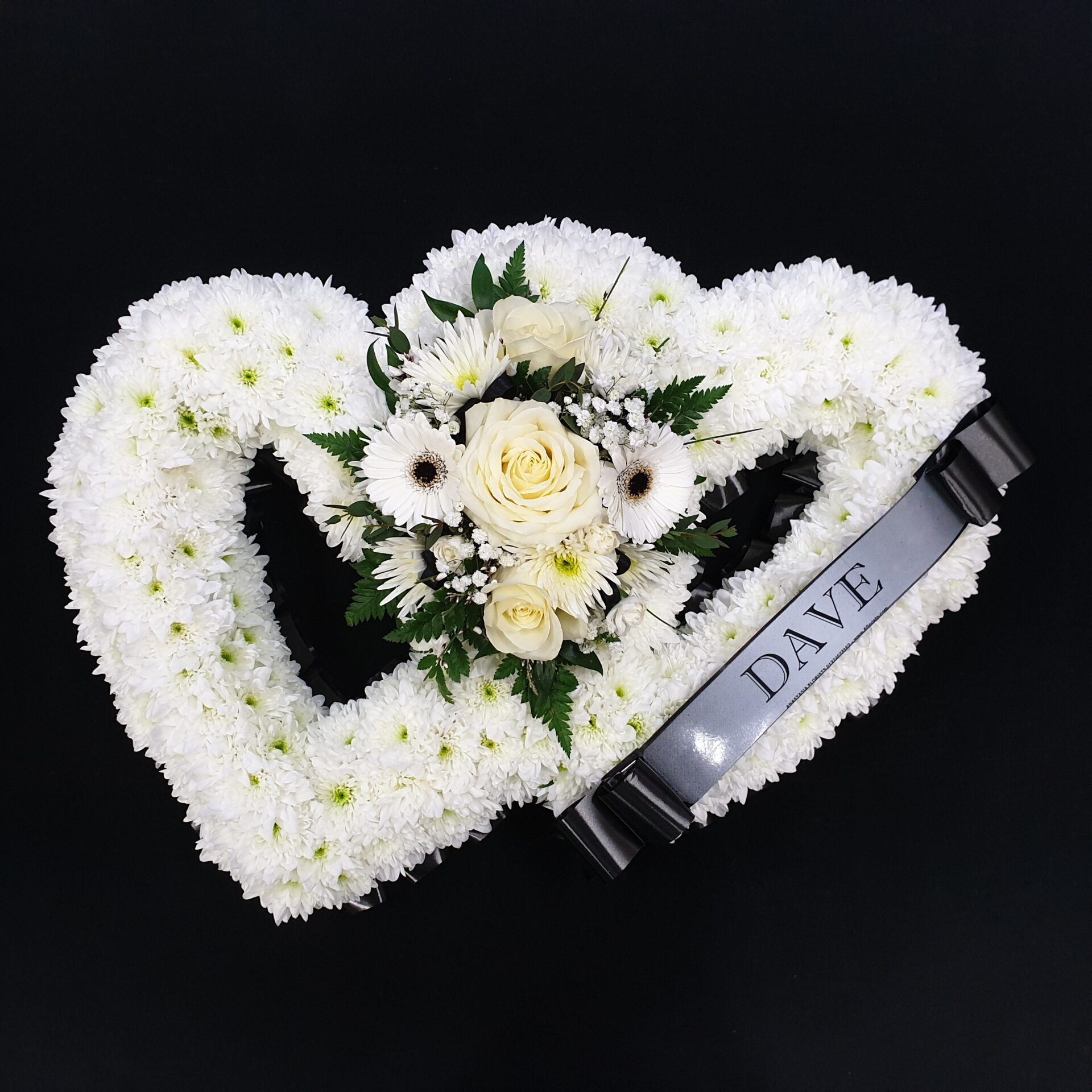 Double open heart funeral tribute with white flowers