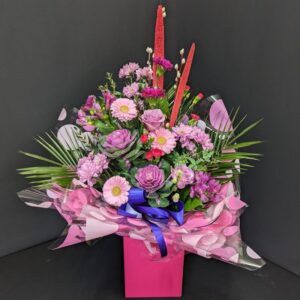 Pretty in Pink gift box flower arrangement with pink and purple blooms, ornamental cabbage and palm foliage in a hot pink box with blue ribbon – Anastasia Florists Aberdeen