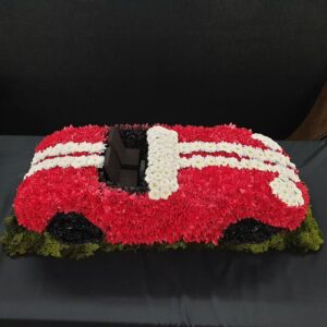 Red and white floral car tribute for funerals