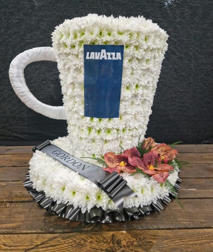Funeral coffee cup tribute with white flowers