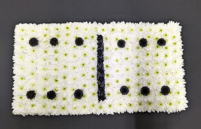 Floral domino tribute with white and black flowers