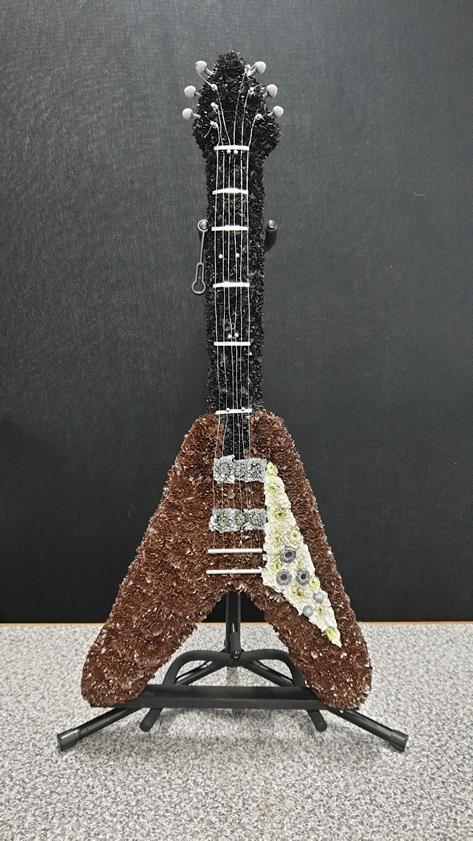 Floral guitar tribute for funeral with elegant blooms