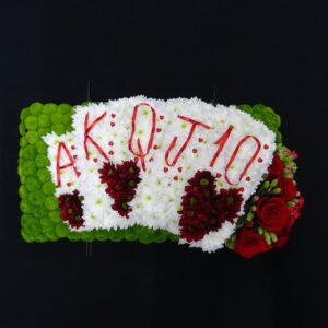 Floral tribute with playing cards design for funeral