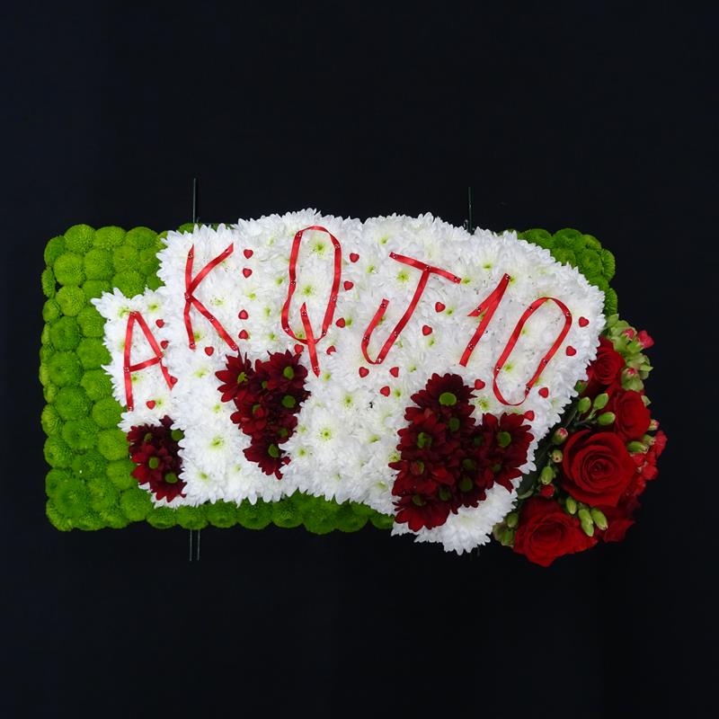 Floral tribute with playing cards design for funeral