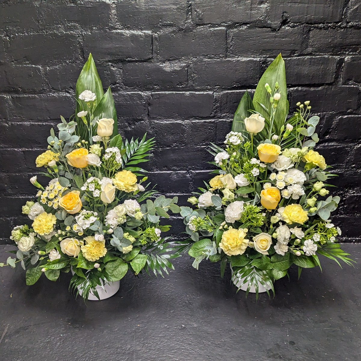 Yellow rose and foliage funeral arrangement – side view