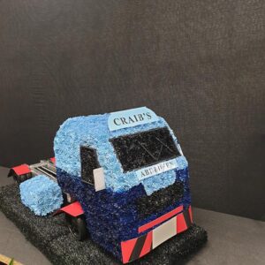 Floral arrangement shaped as a truck, blue and black flowers