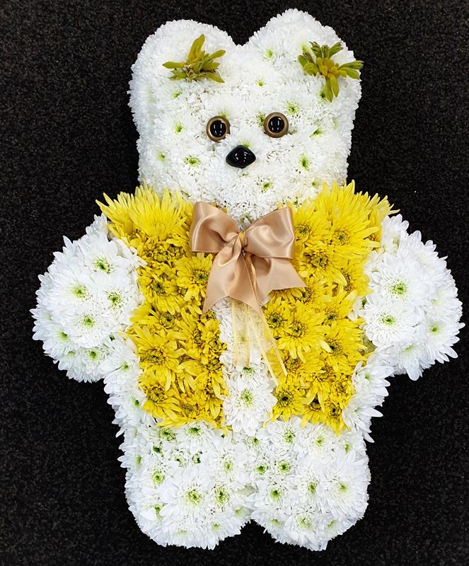 Yellow and white teddy bear funeral tribute made from chrysanthemums with satin bow from Anastasia Florists Aberdeen.