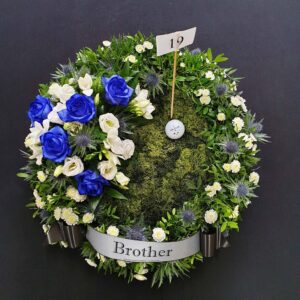 Golf funeral Flowers with blue and white blooms and Golf Ball