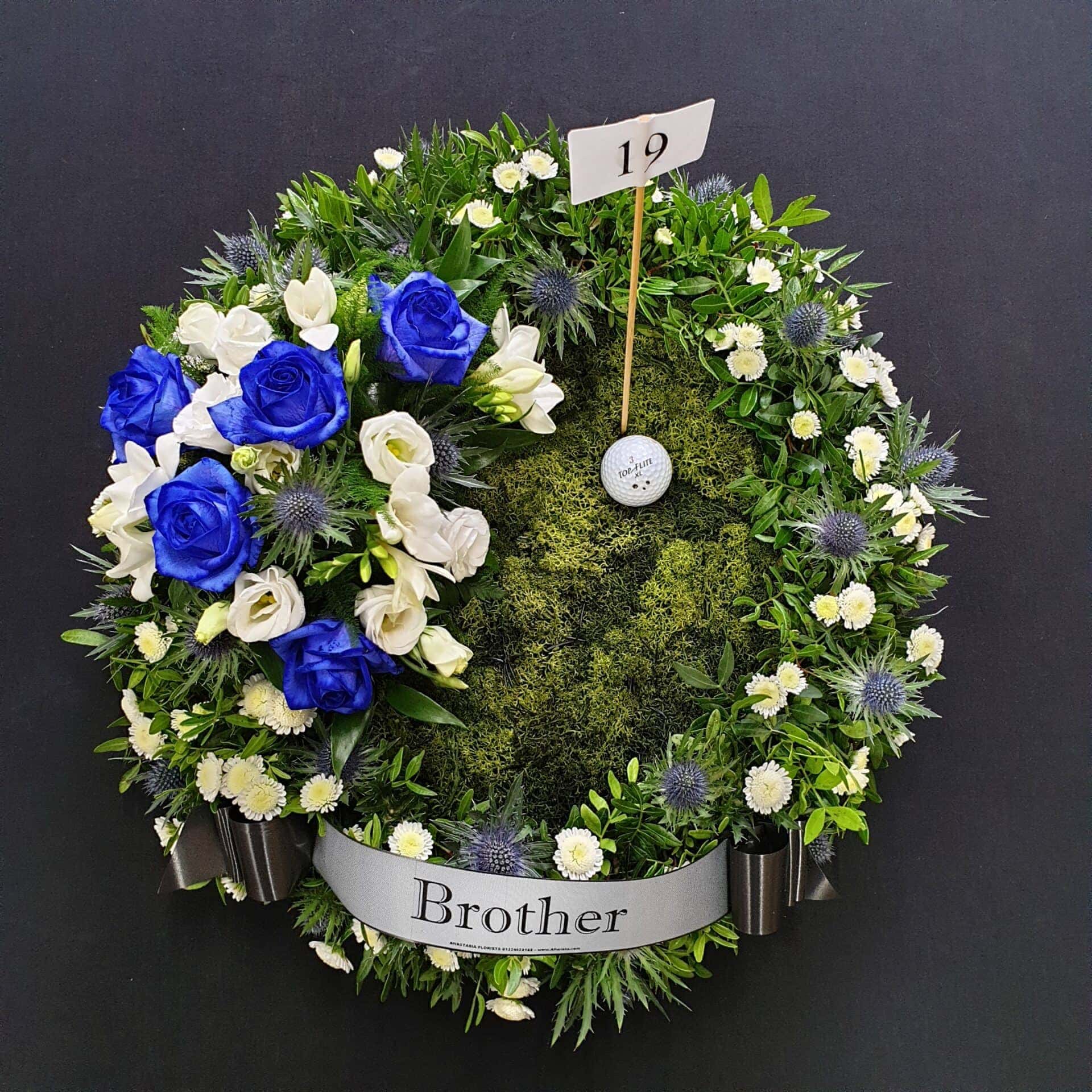 Golf funeral Flowers with blue and white blooms and Golf Ball