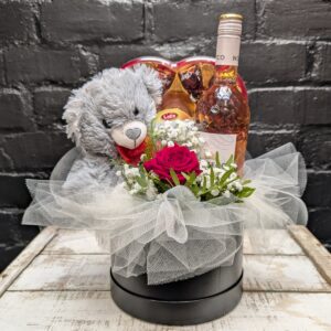 Romantic hat box gift with grey teddy bear, heart-shaped chocolates, bottle of non-alcoholic rosé and single red rose with gypsophila and tulle – Anastasia Florists Aberdeen