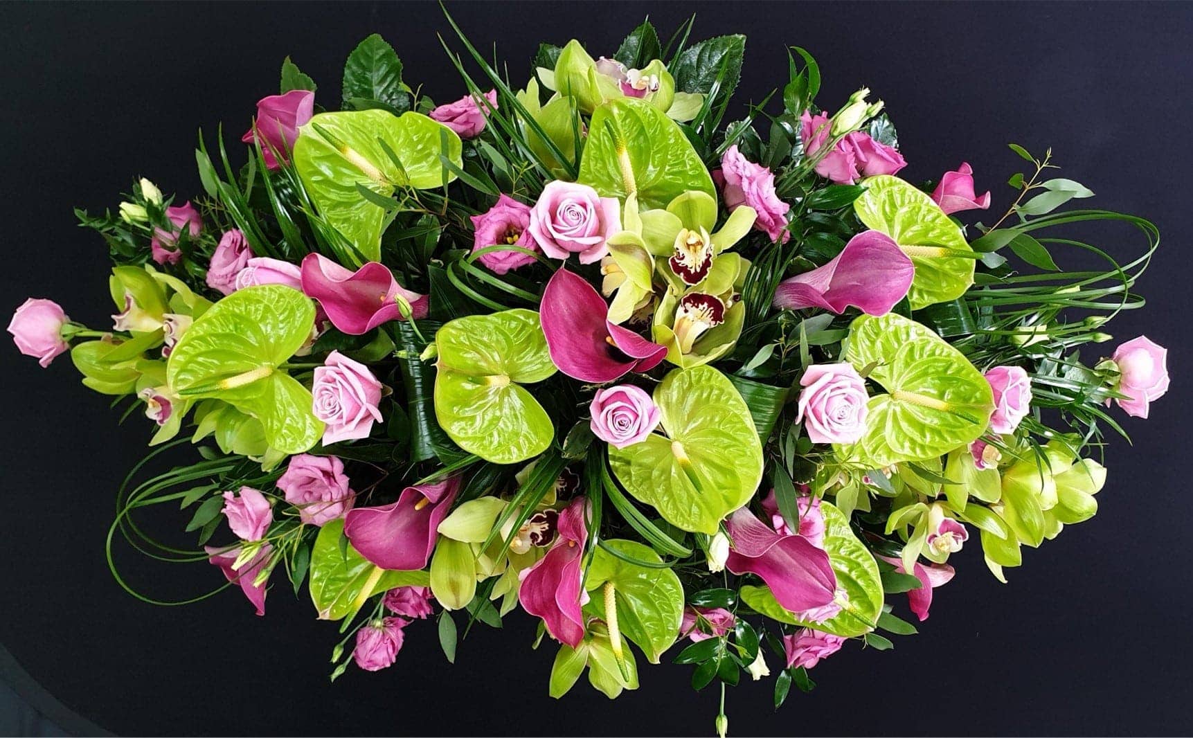 Modern pink and lime green coffin spray with anthuriums, calla lilies, orchids and roses