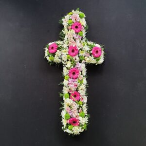 Modern pink and white funeral cross with gerberas, orchids and green button chrysanthemums