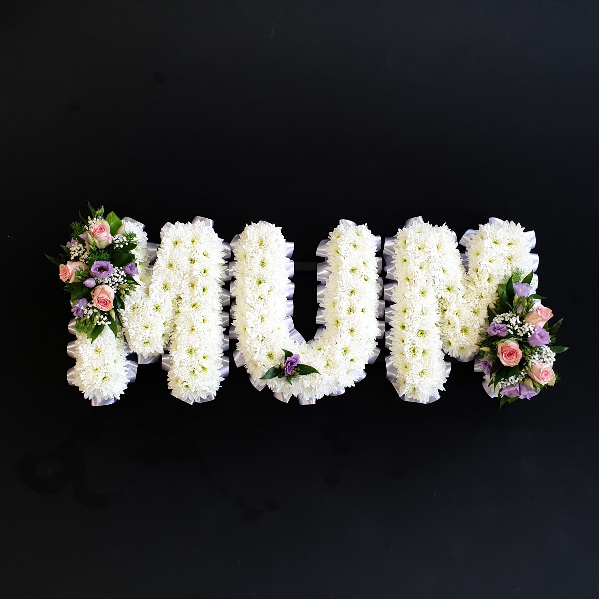 White chrysanthemum funeral letter arrangement spelling 'MUM'
