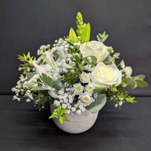 Naomi Pot white flower arrangement with roses, lilies, Gypsophila and greenery in a speckled ceramic pot – Anastasia Florists Aberdeen