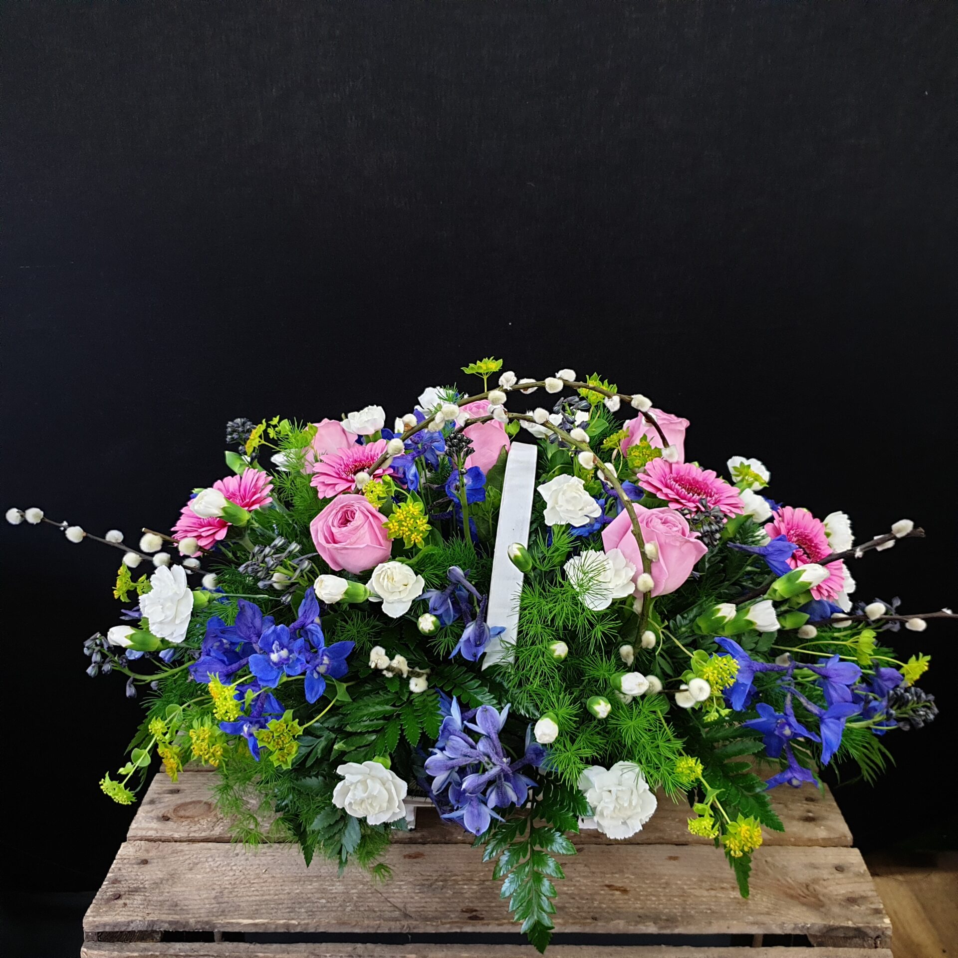 Spring garden funeral flower basket with pink roses, blue flowers, white carnations and pussy willow from Anastasia Florists Aberdeen.