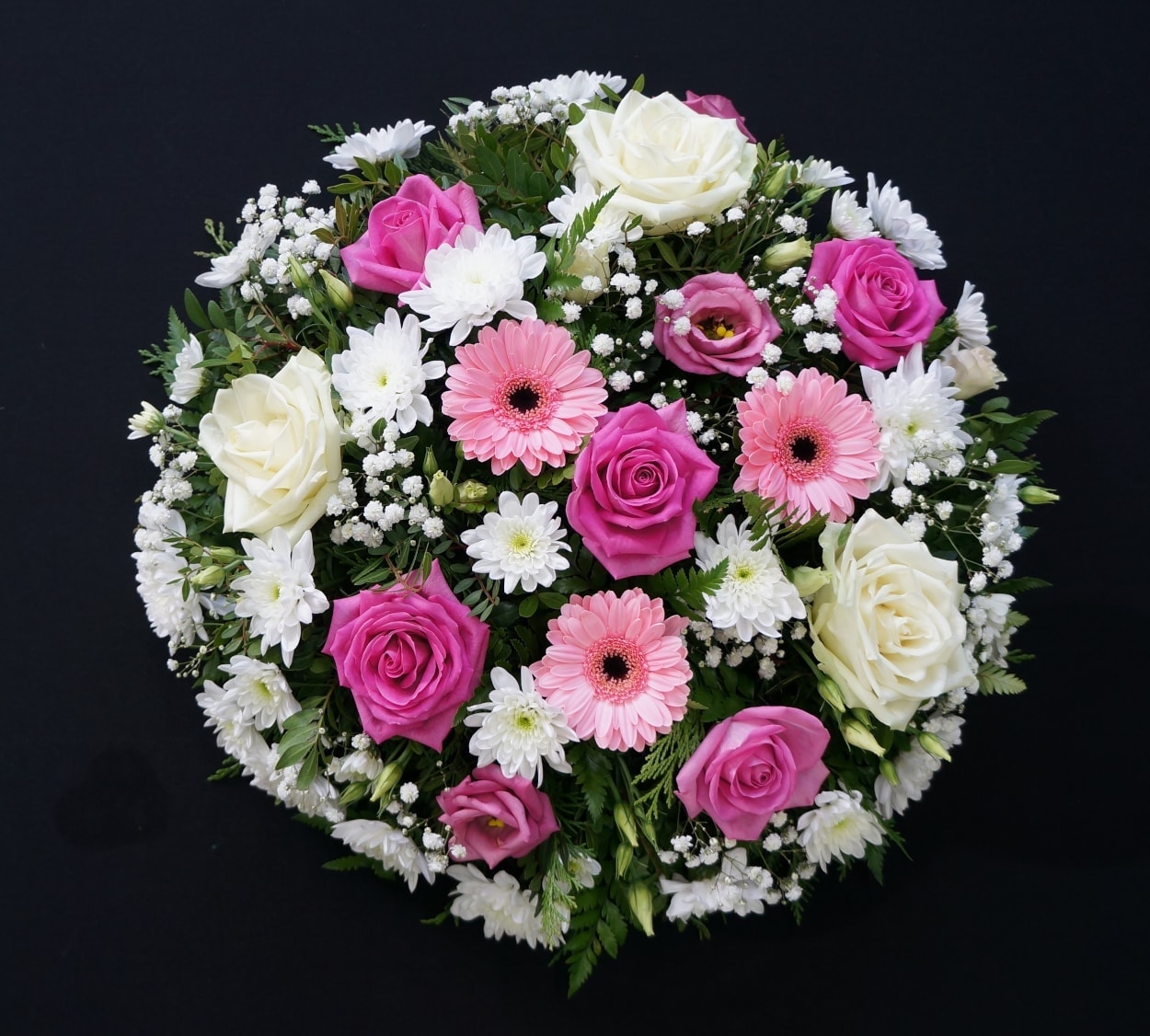 Pink and white funeral posy with pink gerberas, pink and ivory roses and white chrysanthemums