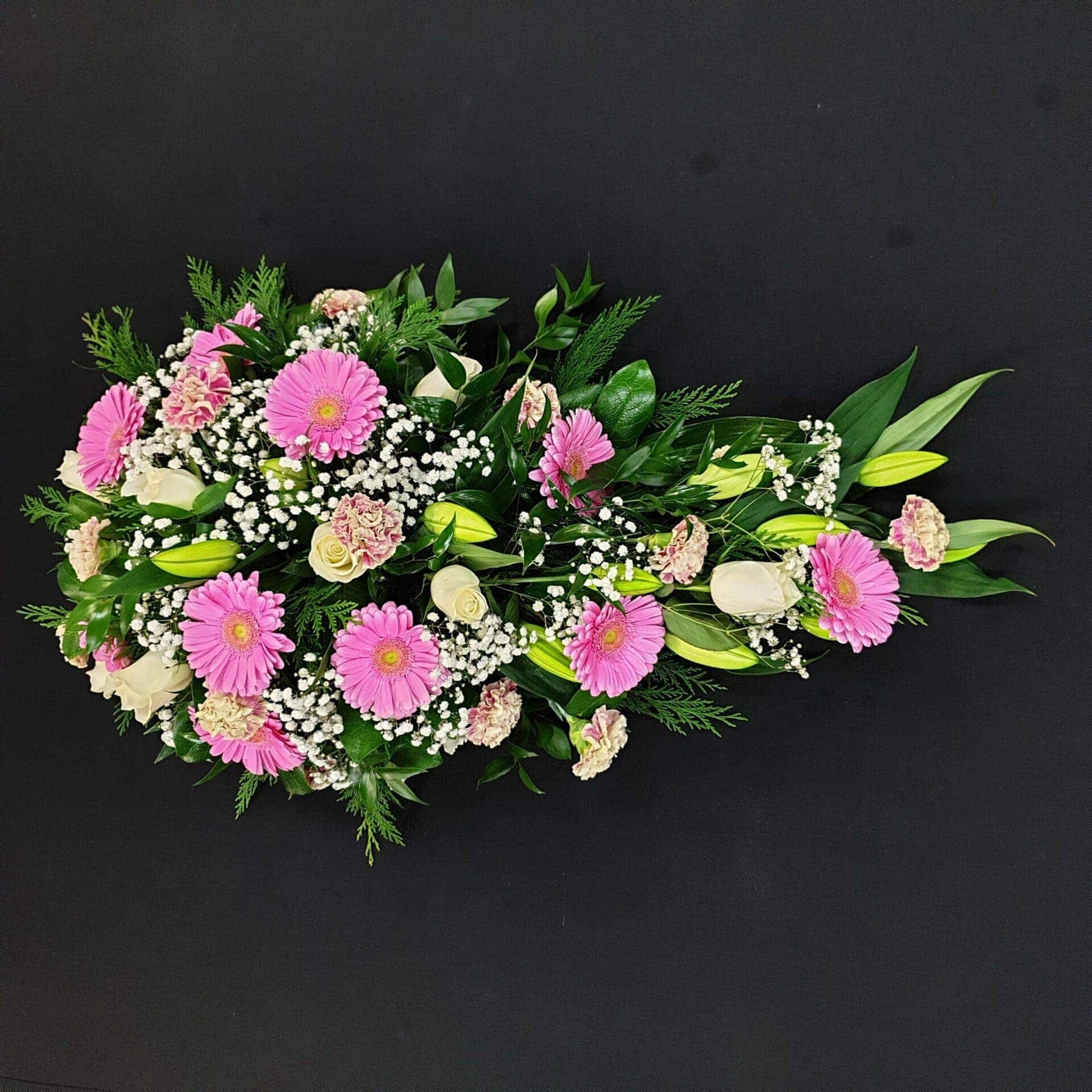 Pink gerbera and white rose funeral spray arrangement