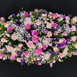 Pink and lilac coffin spray with roses, chrysanthemums, carnations and gypsophila