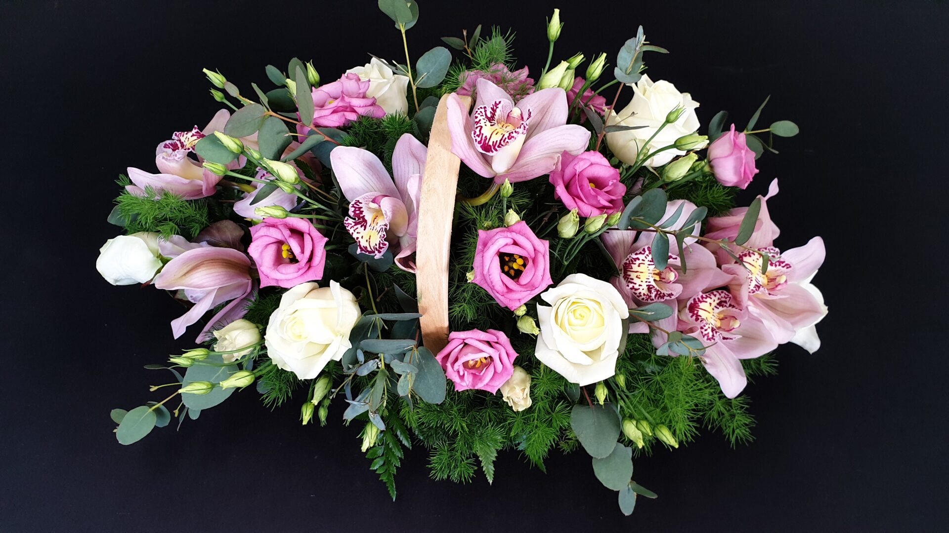 Pink and white funeral flower basket arrangement