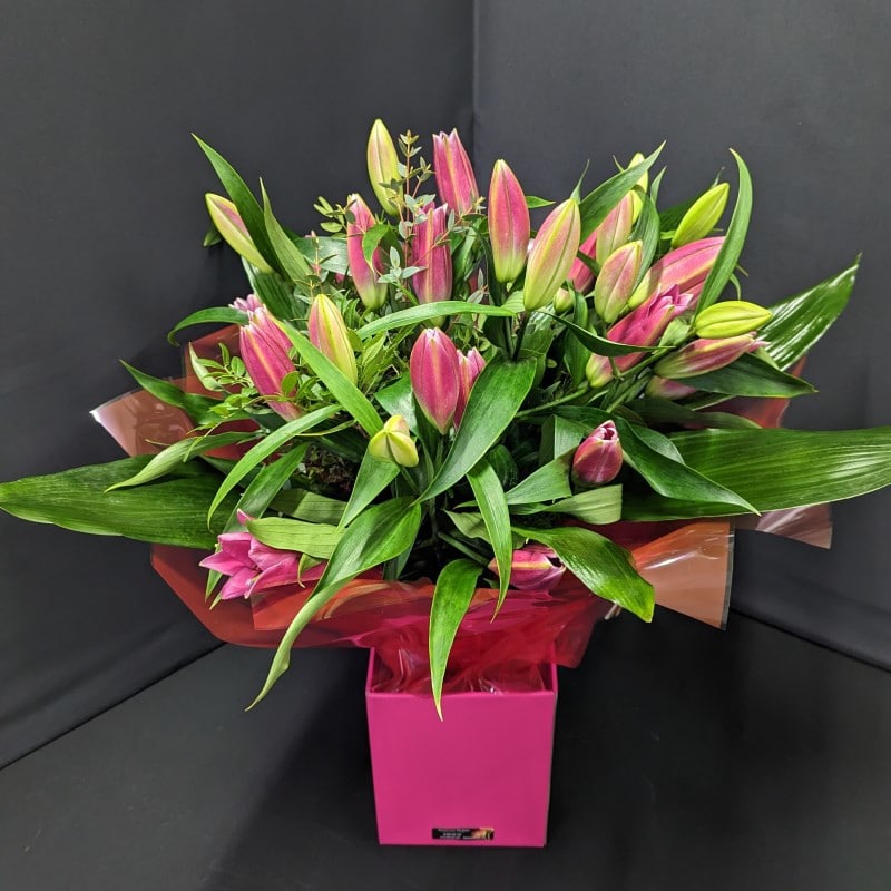 Pink lily and greenery bouquet in pink box – side view