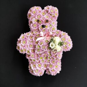 Pink teddy bear funeral tribute made from chrysanthemums with pink bow and white rose posy from Anastasia Florists Aberdeen.