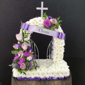White and purple funeral flower arch tribute