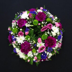 Vibrant funeral flower wreath with assorted flowers