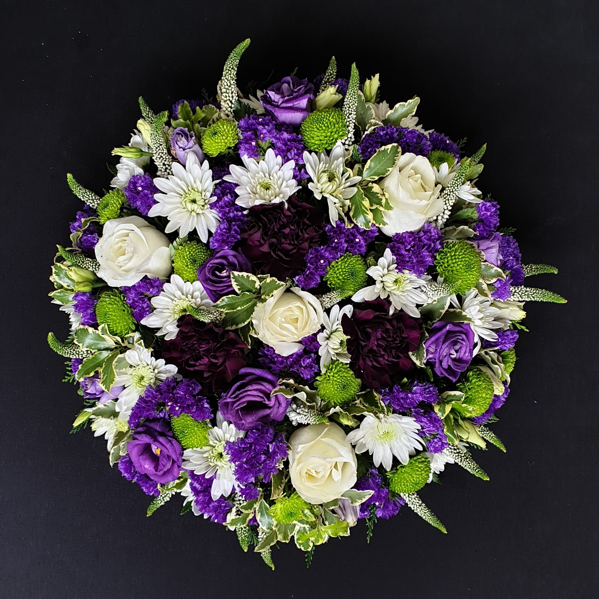 White and purple funeral posy with roses and chrysanthemums