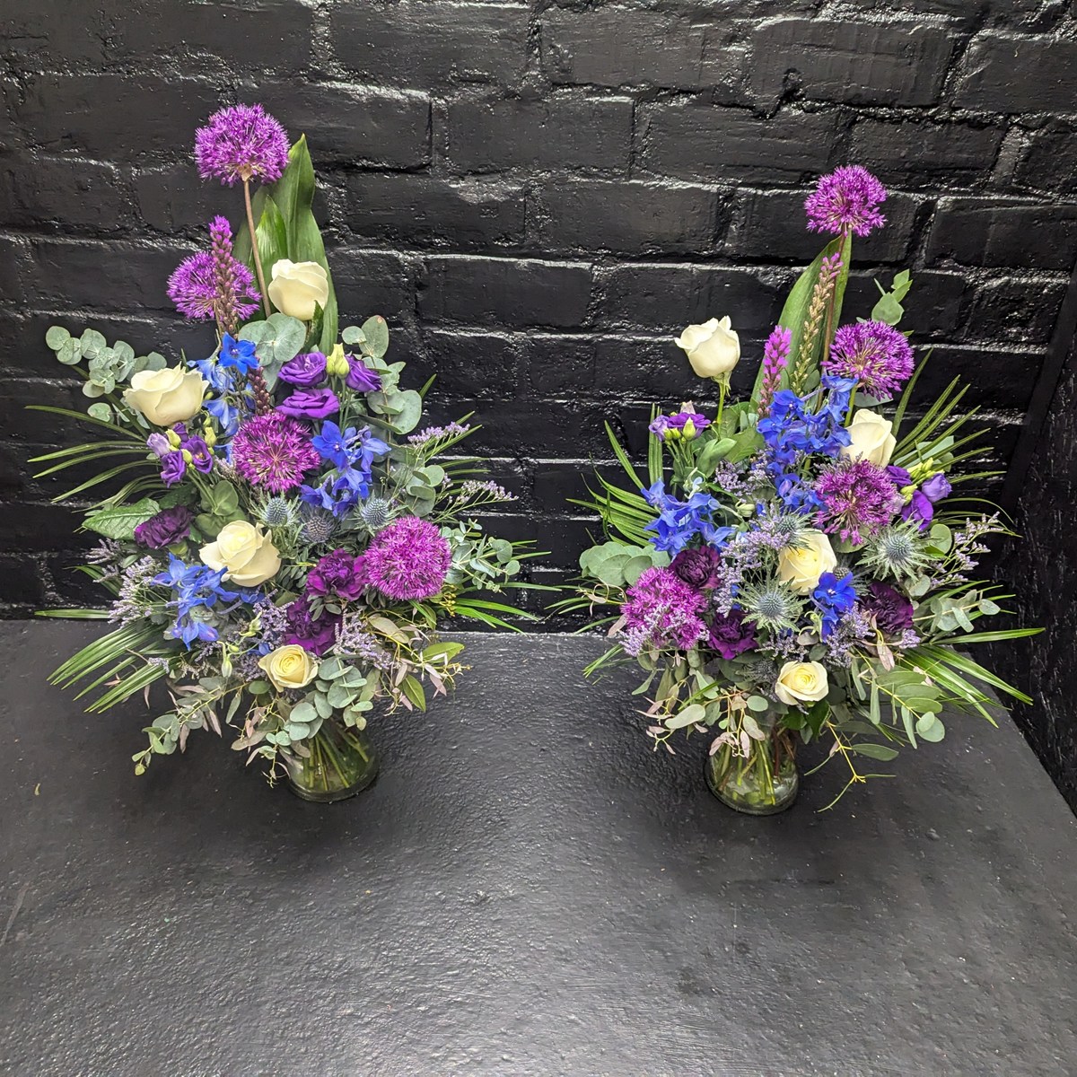 Purple and white floral funeral arrangement – close-up