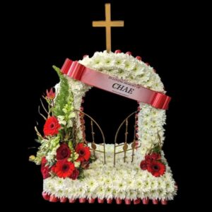 White chrysanthemum and red rose funeral tribute with a cross