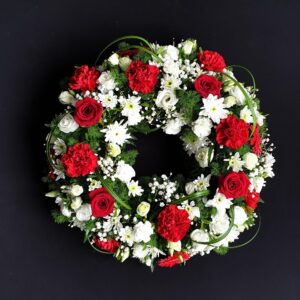 Red rose and white flower funeral wreath tribute.