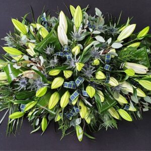 Scottish white lily coffin spray with blue thistles, eucalyptus and tartan ribbon