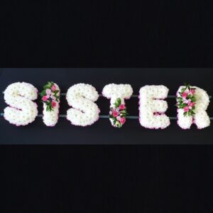 SISTER funeral letter tribute with white chrysanthemums, pink ribbon edging and pink rose sprays