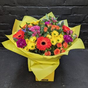 Sophia Bouquet bright mixed flowers with orange gerberas, yellow daisies, orange spray roses and pink blooms in a yellow gift box – Anastasia Florists Aberdeen